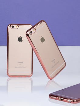 Two rose gold smartphones elegantly displayed against a purple backdrop, perfect for tech ads.